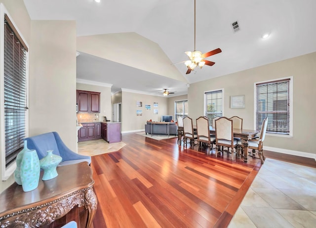 dining space with high vaulted ceiling, ceiling fan, light tile flooring, and ornamental molding