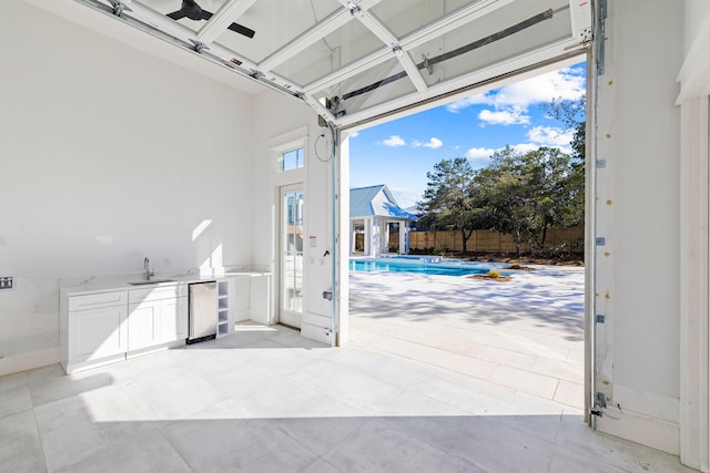 garage featuring sink and a fenced in pool