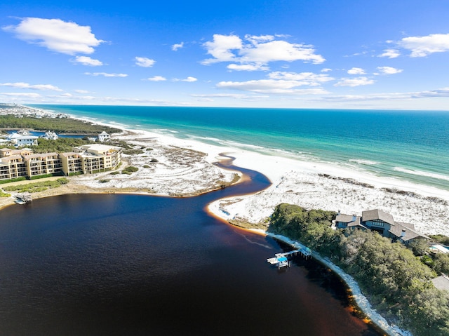 birds eye view of property with a water view and a view of the beach