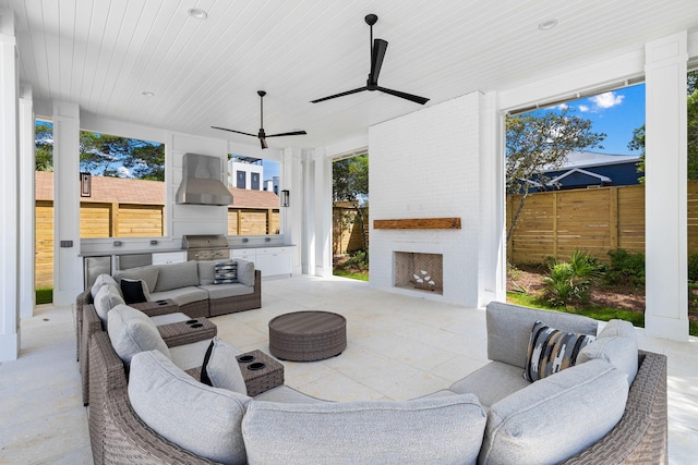 view of patio / terrace with an outdoor living space, ceiling fan, and an outdoor kitchen