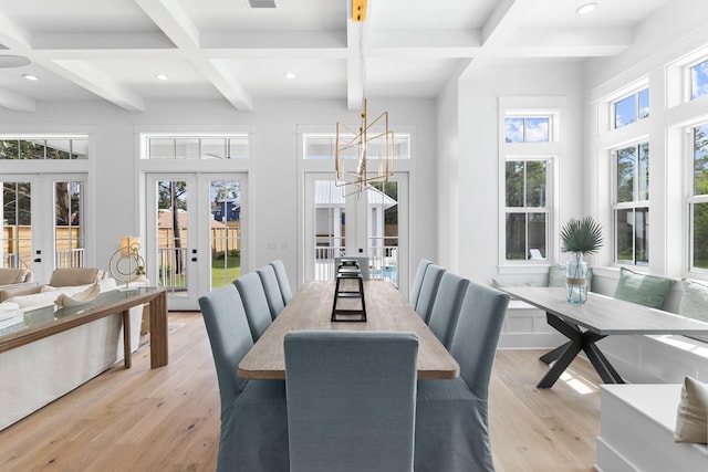 dining space featuring french doors, coffered ceiling, light hardwood / wood-style floors, and beamed ceiling