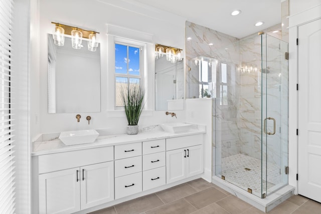 bathroom featuring dual sinks, an enclosed shower, tile floors, and vanity with extensive cabinet space