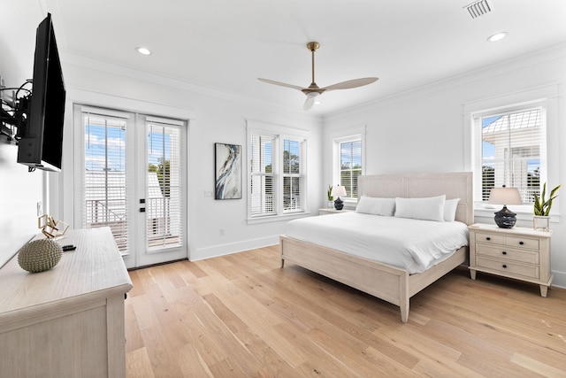 bedroom with access to outside, light hardwood / wood-style flooring, and multiple windows