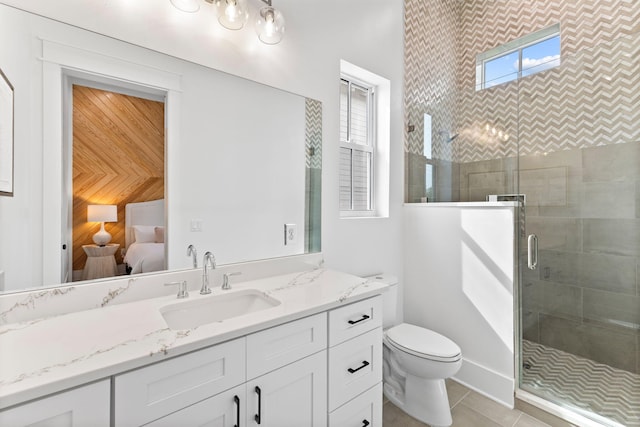 bathroom with tile floors, toilet, oversized vanity, and an enclosed shower