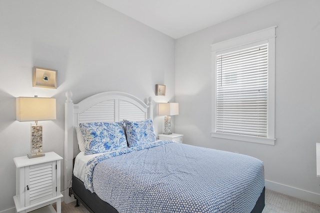 bedroom featuring light carpet