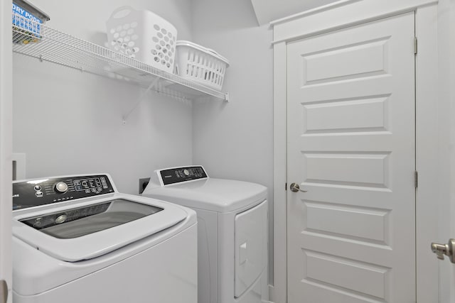 washroom with washing machine and clothes dryer