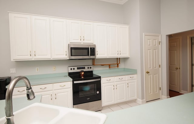 kitchen with sink, white cabinetry, and stainless steel appliances