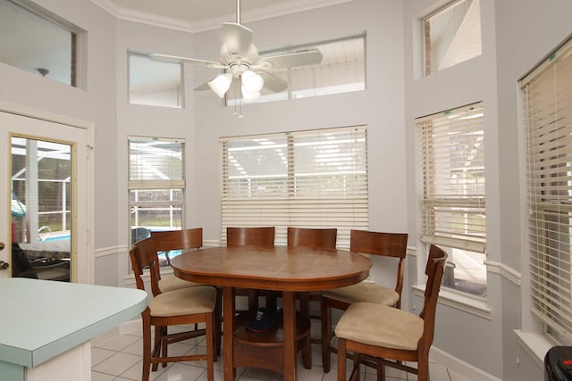 tiled dining room featuring ceiling fan and ornamental molding