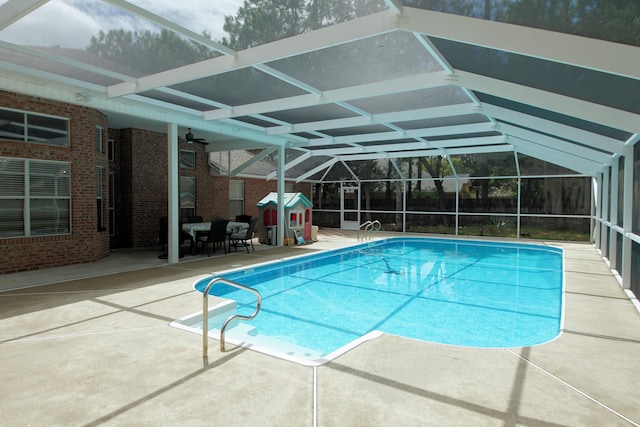 view of pool with a patio area and a lanai