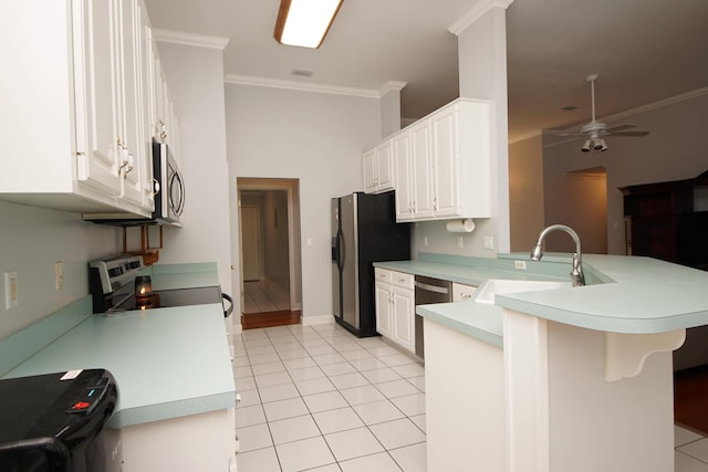 kitchen with white cabinets, kitchen peninsula, sink, and appliances with stainless steel finishes