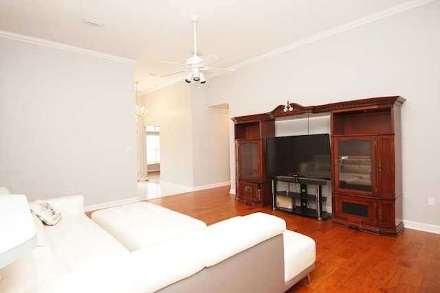 living room featuring crown molding, wood-type flooring, and ceiling fan with notable chandelier