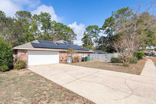 view of front of home with a garage and solar panels