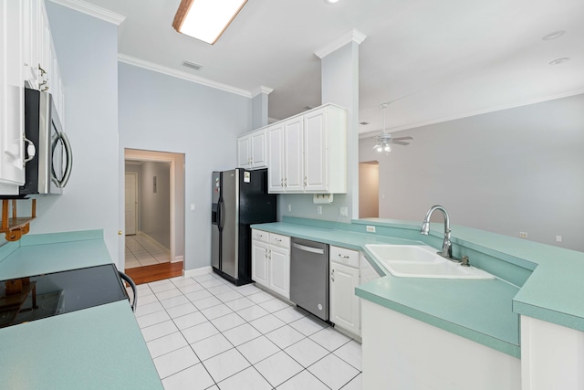 kitchen with sink, light tile patterned floors, white cabinets, and appliances with stainless steel finishes