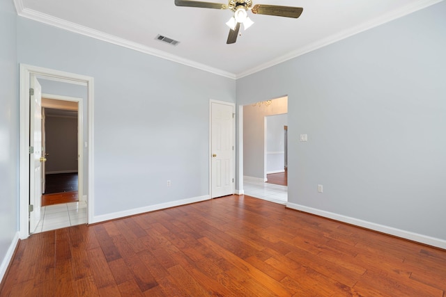 spare room with wood-type flooring, ornamental molding, and ceiling fan