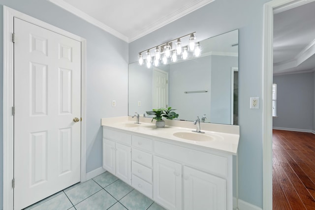 bathroom featuring tile patterned flooring, ornamental molding, and vanity