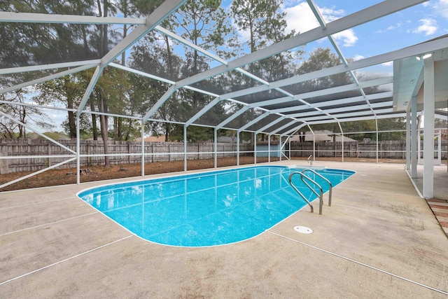 view of swimming pool featuring a patio and glass enclosure