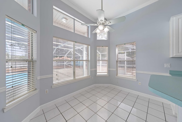 unfurnished dining area with light tile patterned floors, a wealth of natural light, and ceiling fan