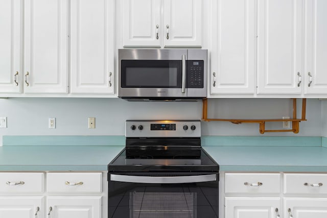 kitchen featuring white cabinetry and appliances with stainless steel finishes