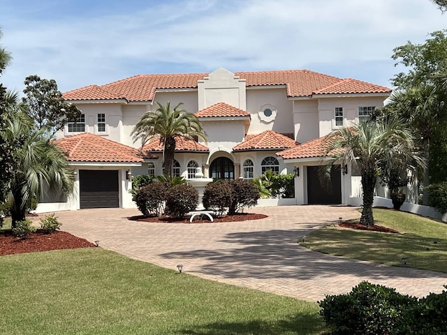 mediterranean / spanish-style house featuring a front yard