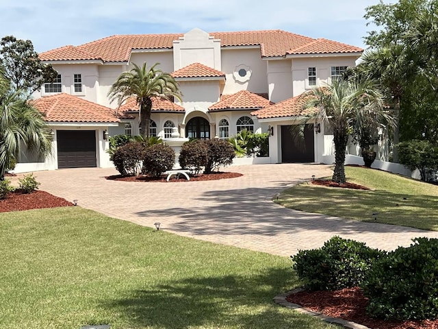 mediterranean / spanish-style home with a front yard