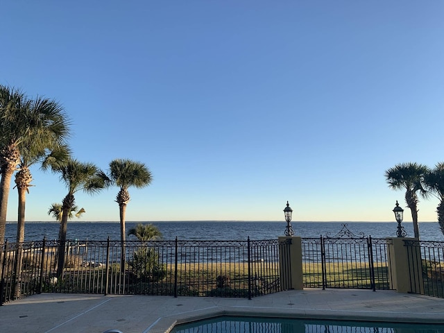 view of swimming pool with a water view