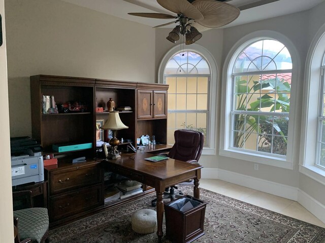 office space with ceiling fan and light tile patterned floors