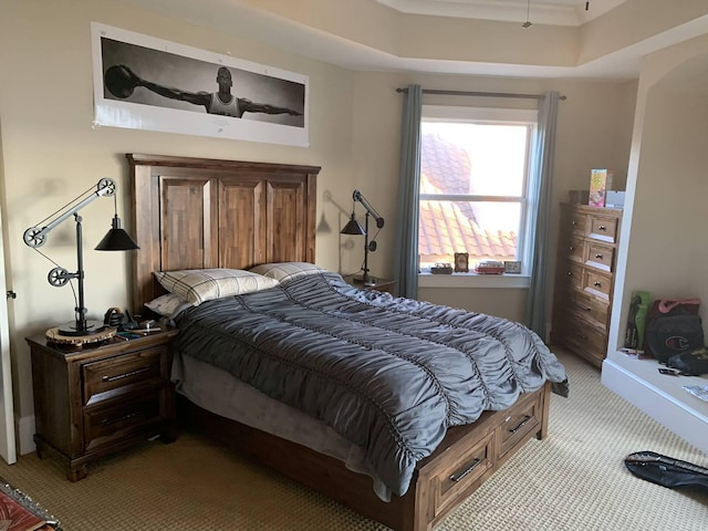 carpeted bedroom featuring a tray ceiling