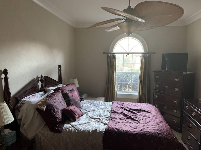 bedroom with ceiling fan and crown molding