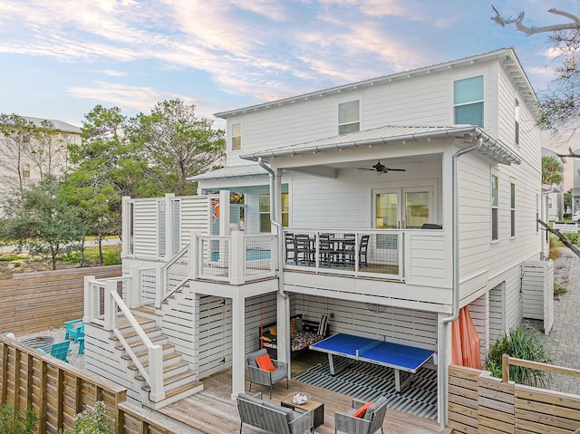 back of house featuring ceiling fan and a deck