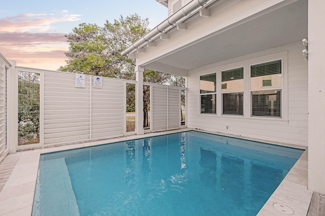 view of pool at dusk