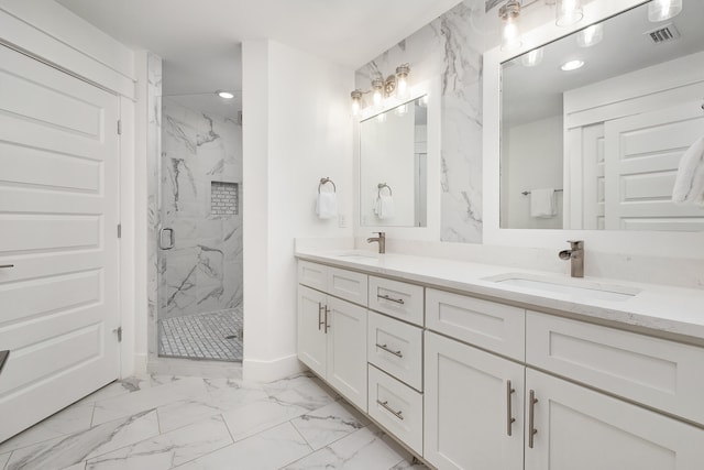 bathroom with vanity with extensive cabinet space, double sink, a shower with shower door, and tile flooring