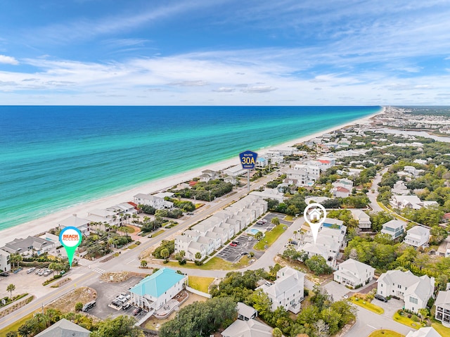 bird's eye view featuring a water view and a beach view