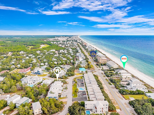 drone / aerial view featuring a water view and a beach view