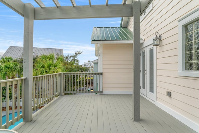 deck featuring french doors and a pergola