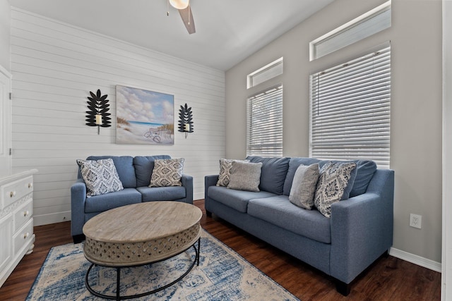 living room featuring dark wood-type flooring and ceiling fan