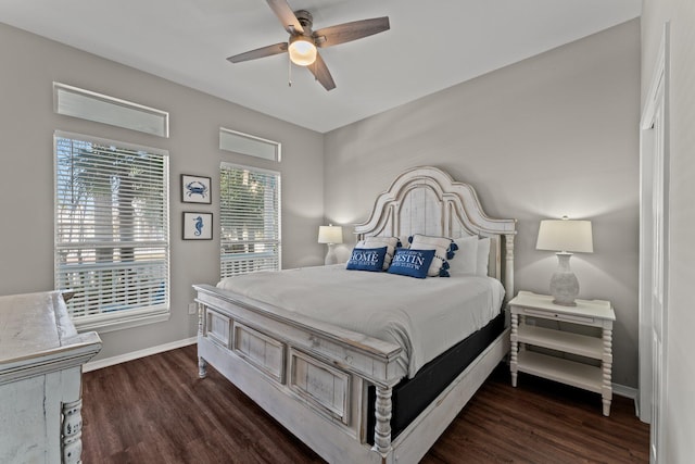 bedroom featuring ceiling fan, multiple windows, and dark wood-type flooring