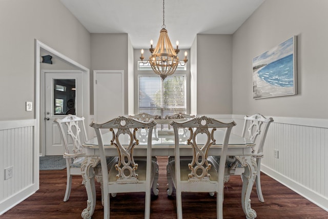 dining area featuring a notable chandelier and dark hardwood / wood-style flooring