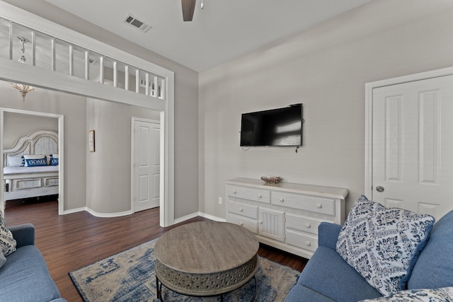 living room with ceiling fan and dark hardwood / wood-style floors