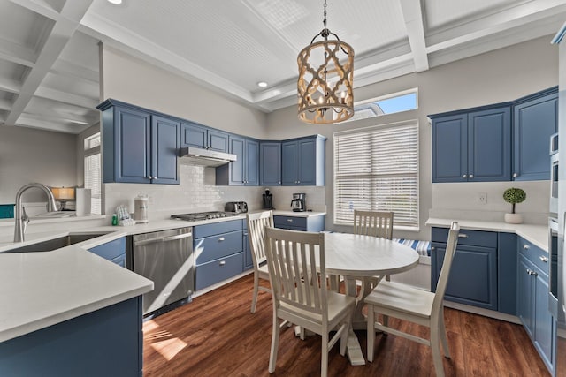 kitchen featuring decorative light fixtures, coffered ceiling, stainless steel appliances, and dark wood-type flooring