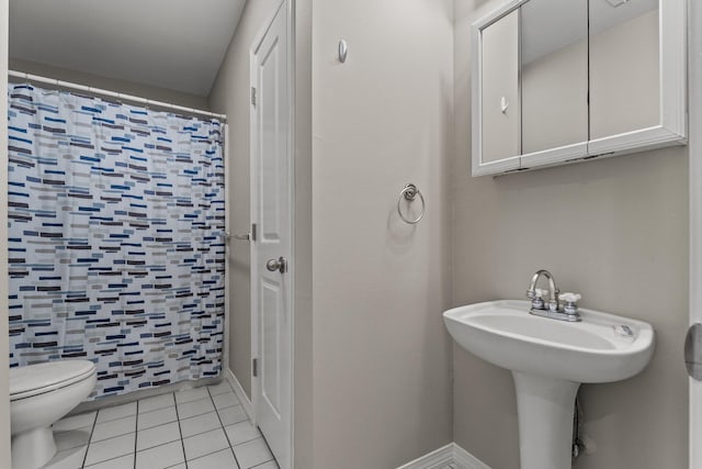 bathroom featuring toilet and tile flooring