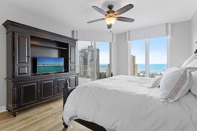 bedroom with access to exterior, ceiling fan, and light hardwood / wood-style flooring