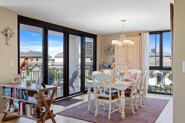 dining space featuring a notable chandelier and wood finished floors