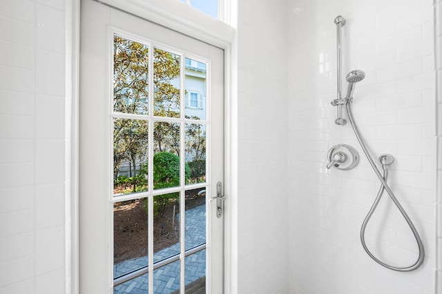 interior details featuring a tile shower