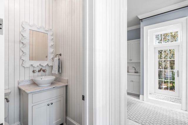 bathroom featuring ornamental molding, vanity, toilet, and a wealth of natural light