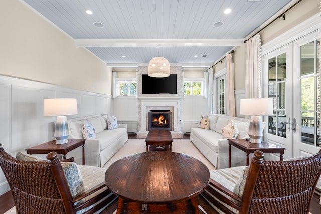 living room with wood ceiling, french doors, crown molding, and light wood-type flooring