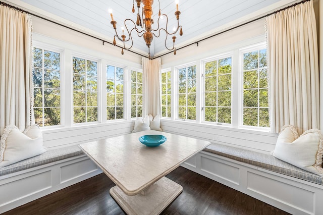 sunroom featuring an inviting chandelier