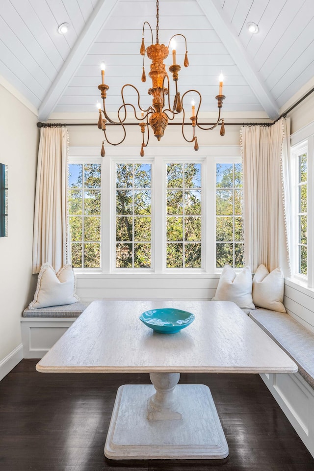 unfurnished room with dark hardwood / wood-style flooring, lofted ceiling with beams, and a chandelier