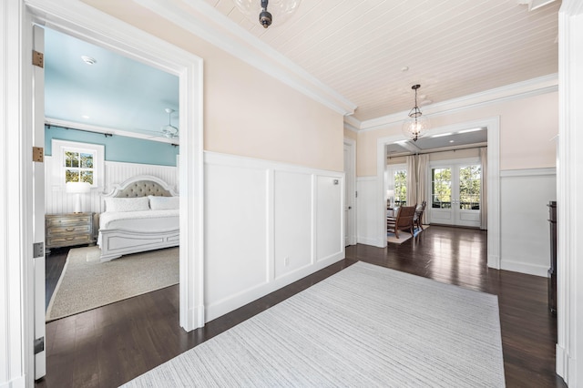 interior space with dark hardwood / wood-style floors, french doors, and ornamental molding