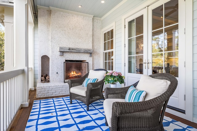 balcony featuring a brick fireplace