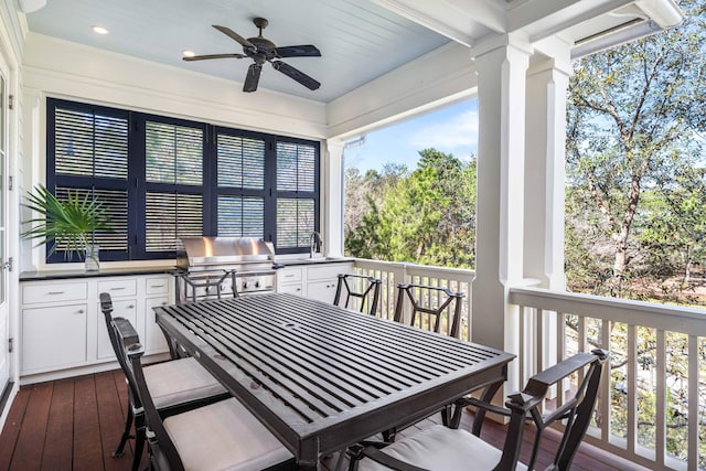 deck featuring ceiling fan, an outdoor kitchen, and grilling area